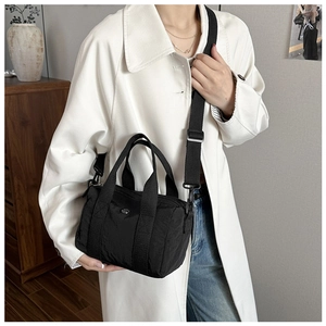 Black nylon multi-pocket crossbody bag shown with model for size and fit reference