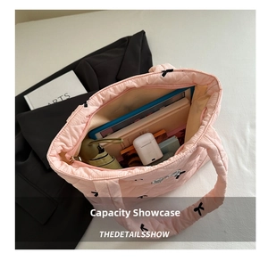 Pink quilted tote bag interior view showing large storage capacity for tablets and books