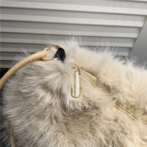 Chic beige plush tote bag with gold zipper and premium leather shoulder strap detail