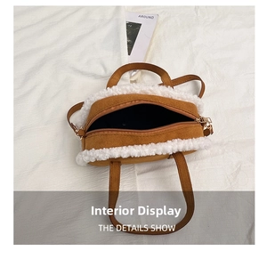 Top view of brown suede and white faux shearling tote bag with a zipper on a textured background