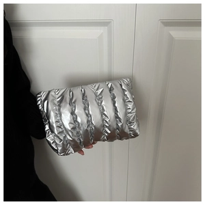 Detailaufnahme der silbernen Stepp-Clutch mit glänzendem Plissee-Finish und Polster-Effekt