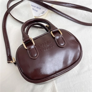 Mini chocolate patent leather bag with embossed logo and gold-tone hardware detail