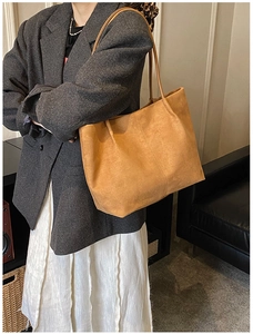 Brown suede tote bag styled with a grey wool blazer and white pleated skirt
