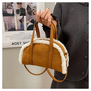 Detail of plush tote bag showing brown suede and white faux fur trim with zipper