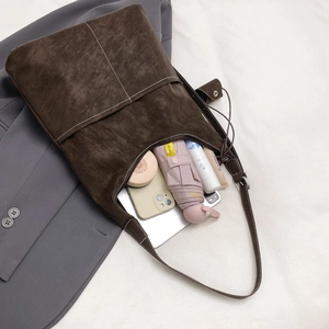 Large dark brown soft leather tote bag with white contrast stitching for commuting