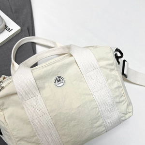 Creamy white nylon multi-pocket shoulder bag with pleated texture and top handles