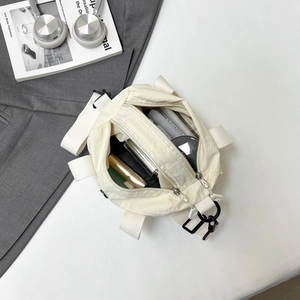 Off-white nylon crossbody bag with multi-pocket interior for daily essentials