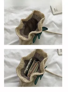 Interior view showing straw bucket bag capacity with phone and wallet inside