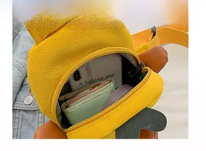 Detail view of internal space in yellow canvas duck crossbody bag for kids
