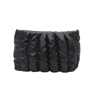 Minimalist black quilted cosmetic bag with cloud-like puffed design and metal zipper