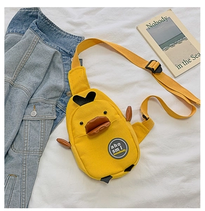 Detail of yellow canvas duck chest bag with orange beak pocket and adjustable strap