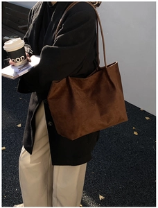 City street scene showing a brown suede tote bag for daily commute and urban lifestyle