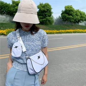White baguette bag with crossbody strap, mini pouch and black planet embroidery details