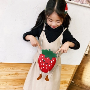 Toddler girl wearing a strawberry shaped crossbody bag with cute face and rope legs