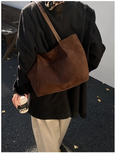 Detailed texture of dark brown suede tote bag with slim shoulder straps for daily use