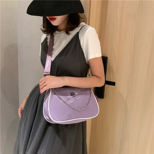 Purple crossbody bag with silver chain and planet embroidery shown on a female model