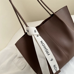 Large dark brown tote bag in smooth faux leather with stylish letter ribbon detail