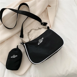 Close-up of black nylon half-moon bag with silver planet embroidery and chain