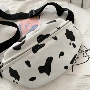 Detail of cow print canvas waist bag with adjustable strap and smooth zipper closure