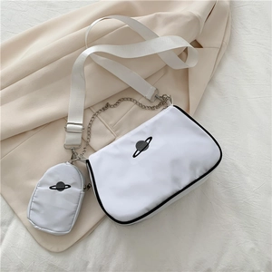 Close-up of white nylon crossbody bag with black planet embroidery and silver metal chain