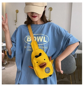 Detail shot of cute yellow duck 3D canvas crossbody bag with 3D wings and orange bill