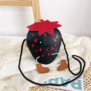 Close-up of cute strawberry-shaped girl's crossbody bag in black PU leather with dot patterns