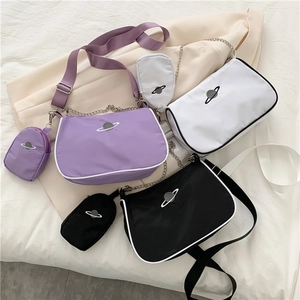 Three baguette bags in purple, white, black with matching coin purses and planet embroidery