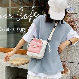 Detail view of canvas crossbody bag with pink rabbit ears and Chong ya print