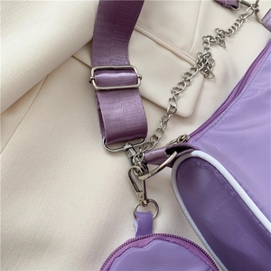 Detail of purple nylon baguette bag with silver chain and detachable round coin purse
