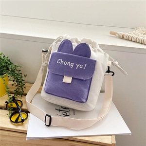 Japanese style canvas bucket bag with rabbit ears and adjustable strap in lifestyle setting