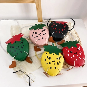 Flat lay of colorful strawberry shaped crossbody bags for kids in five vibrant colors