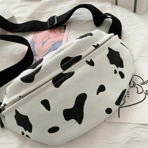 Chic cow print canvas chest bag with adjustable black strap and cow pattern design