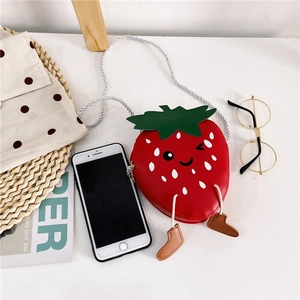 Close-up of cute strawberry-shaped kids' crossbody bag with leaf detail and small feet