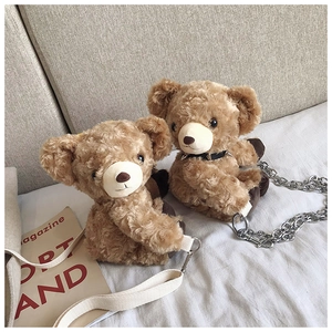 Detail showing two plush bear crossbody bags with metal chain and canvas strap options