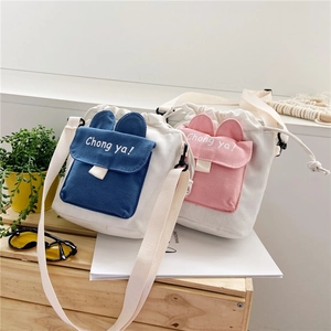 Detail of canvas bucket bags with cute rabbit ears and 'Chong ya!' letter printing