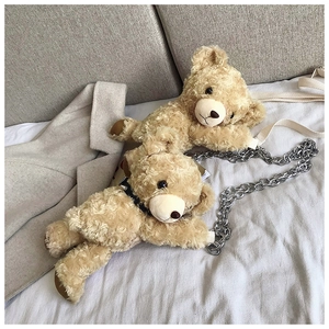Detailed view of plush teddy bear bags with curly faux fur and silver chain strap