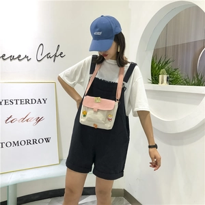 Gros plan sur le sac messager mignon en toile avec rabat rose et broderie cartoon