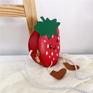 Detailed view of strawberry shaped girls crossbody bag with cute smiling face and tiny legs