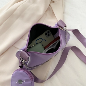 Purple nylon baguette bag with chain strap and mini coin purse showing large capacity