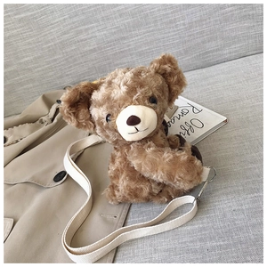 Detail of cute brown plush bear crossbody bag with soft curly faux fur and silver hooks