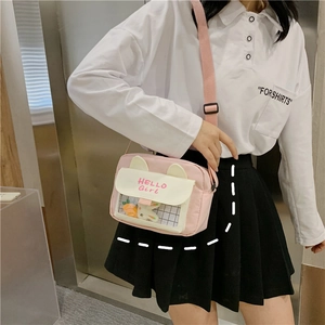 Detail of pink canvas crossbody bag featuring rabbit ears and a transparent window