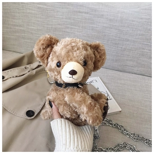 Detail of brown plush bear bag with punk rivet collar and silver metal chain
