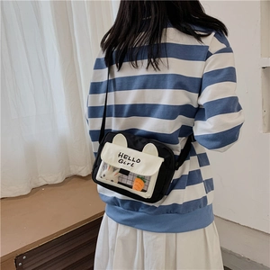 Detail view of canvas crossbody bag with cute rabbit ears and HELLO Girl lettering