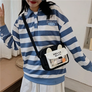 Detail of cartoon bunny ear flap and transparent PVC window on small canvas crossbody bag