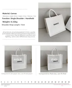 Detailed view of white canvas tote bag with 'merci' print, measuring 34.5x31.5x17cm