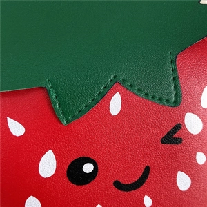 Close-up of strawberry shaped girls handbag showing high-quality red pebble grain leather