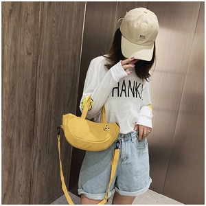 Détail du sac bandoulière en toile jaune avec broderie et sangle réglable