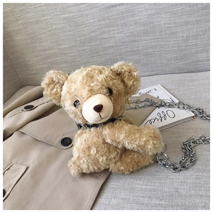 Detail of teddy bear plush bag with curly faux fur and chunky silver chain strap
