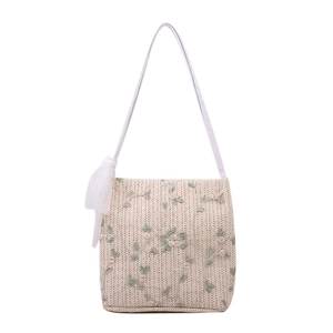 Straw shoulder bag with floral embroidery and white lace bow in cream white finish