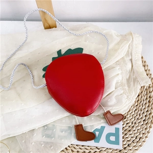 Cute strawberry-shaped red crossbody bag for girls with leaf decor and small boot charms